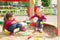 Conflict on the playground. Two kids fighting over a toy shovel in the sandbox