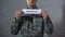 Conflict word written on sign in hands of soldier, military annexation, war