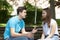 Conflicted couple not talking to each other seated on a wooden bench in park