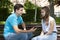 Conflicted couple not talking to each other seated on a wooden bench in park