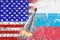 Confrontation between the USA and Russia. Threat of nuclear strike. The flags of two countries painted on the concrete wall.