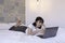 Confuse asian beautiful girl when work the laptop in the bed. Work from home concept