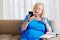 Confused aged woman with smartphone