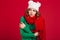 Confused brunette woman in sweater, funny hat and scarf