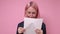 Confused caucasian woman in business clothing reading a report or preparing to speak.