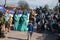 Confused child stood in the middle of an outdoor fancy dress party