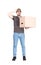 Confused delivery man, full length portrait, holding a cardboard box while keeps a hand to head, isolated on white. Puzzled