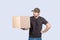 Confused Delivery man  holding a box  over white background. Don`t know what to do