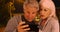 Confused elderly couple lost in a different country and uses smartphone for help