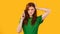 Confused Girl Talking On Phone Standing Over Yellow Background, Panorama