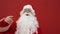 Confused Santa faints on a red wall background. Santa turned his head at Christmas on a red background. Santa is sick