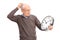 Confused senior holding a big wall clock