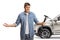 Confused young man holding a manual tire pump in front of a SUV
