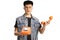 Confused young man holding an orange rotary phone