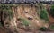 Confusion of wildebeests going down the rock formation in Masai Mara, Kenya