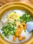 Congee, Rice Porridge, Rice Gruel, Conjee or Rice Soup topped with ginger, spring onion and small donut-like pathongko or deep fr