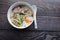 Congee, Rice soup, Rice porridge with egg in the bowl and spoon, Thai morning delicious food isolated on wooden wallpaper
