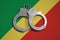 Congo flag and police handcuffs. The concept of observance of the law in the country and protection from crime