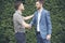 Congratulation to collaboration partner after sign on contract. Diverse Businessman shake hands together with businessman to