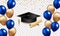 Congratulations graduation. Class of 2023. Graduation cap and confetti and balloons. Congratulatory banner in blue. Academy of