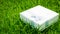 Congratulations Topic: pretty white box with a white ribbon with gifts lying on green grass