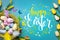 Congratulatory easter background. Easter eggs and flowers. Selective focus. Top view.