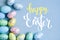 Congratulatory easter background. Easter eggs and flowers. Selective focus. Top view.