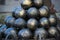 Conical black cannonballs forming an interesting pattern, close up