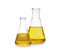 Conical flasks with yellow liquid on white