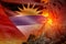 conical volcano blast eruption at night with explosion on Antigua and Barbuda flag background, problems of natural disaster and