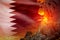 conical volcano blast eruption at night with explosion on Qatar flag background, problems of natural disaster and volcanic