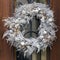 Conifer Christmas wreath with pine cones at door