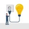 Connect idea. Businessman holding lightbulb, cord electrical plug connected to power outlet.