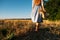 Connect with nature, Slow Down, Be Present, Get Into Your Senses. Barefoot woman in linen blue dress walks through