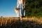 Connect with nature, Slow Down, Be Present, Get Into Your Senses. Barefoot woman in linen blue dress walks through