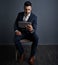 The connected exec is a productive exec. Studio shot of a stylish young businessman using a digital tablet against a