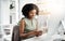 Connected to the things that keep her productive. a young businesswoman using a mobile phone at her desk in a modern