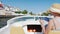 Always connected: woman with a phone in his hand on a boat floats on the channel. The resort town of Empuriabrava