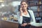 Connecting with customers has never been easier. a young woman using a phone in the store that she works at.