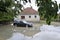 The consequences of flooding, car in front of flooded house.