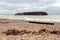 the consequences of a tanker wreck on a sandy beach.