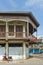 Conserved old mixed concrete and wooden shophouse in downtown Nakhon Phanom, Thailand