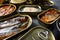 Conserves of canned fish with different types of fish and seafood, opened and closed cans with Saury, mackerel, sprats, sardines,