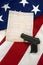 Constitution with Hand Gun on American Flag, Vertical