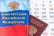 Constitution of the Russian Federation with passport citizen on calendar background