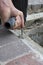 Construc worker fixing the pavestone on the roadtion worker installing stone blocks on pavement