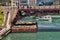 Construction along the Chicago River at Dearborn Street, with barge and cones hanging from bridge to