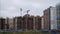 Construction apartment house progress timelapse. Construction site in Russia with cranes on the roof and clouds on a blue sky