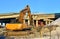 Construction of the automobile bridge. Excavator hydraulic crushes concrete slabs.