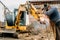 Construction building site, broken excavator and professional welder